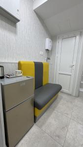 a yellow and black bench in a room at Ava Hostel Yerevan in Yerevan
