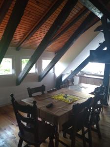 a dining room with a wooden table and chairs at KAM-TECH Krzysztof Kamiński in Krzywy Róg +4 photos