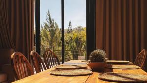 a wooden table with a potted plant on top at Alpine River Cabin with direct access to the river in Río Arriba
