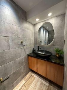 a bathroom with a sink and a mirror at Alpine River Cabin with direct access to the river in Río Arriba +30 photos
