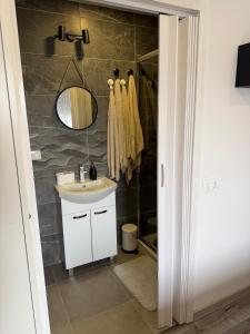a bathroom with a sink and a mirror at Jetlag Bradić in Velika Gorica