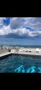 a swimming pool with a view of the beach at Meraki Resort & Spa Isabellae Home in Mamaia Sat/Năvodari