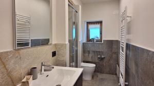ein Badezimmer mit Waschbecken und Toilette in der Unterkunft I Sitoù in Ostana
