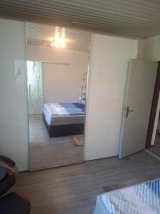 a bedroom with a door open to a bed at Haus Steiner in Kleblach