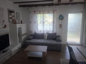 a living room with a couch and a table at Haus Steiner in Kleblach