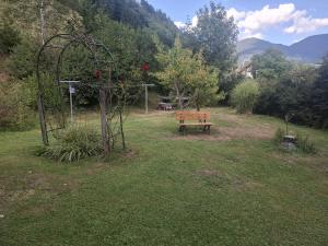 a park with a bench and an arch and a swing at Haus Steiner in Kleblach