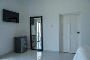 a mirror on a wall next to a bed at Emotions by Ironshore in Montego Bay
