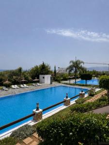 a swimming pool with a view of the water at Mar y piscina in Cabo Negro +2 photos