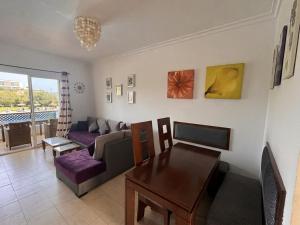 a living room with a couch and a table at Mar y piscina in Cabo Negro