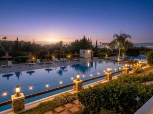 a large swimming pool with lights on it at night at Mar y piscina in Cabo Negro