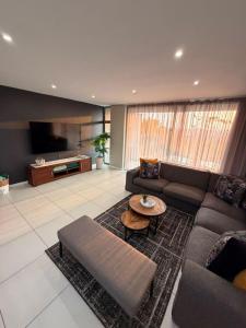 a living room with a couch and a table at Ballito Zimbali Wedge in Ballito
