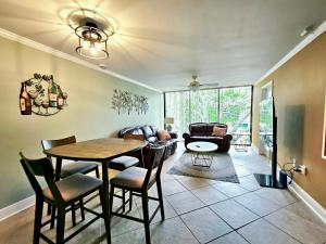 a living room with a table and chairs and a couch at Seaside Treasure in Biloxi