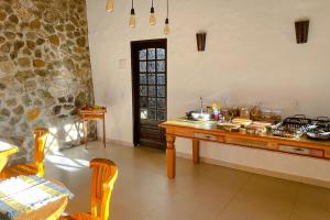 a kitchen with a table with food on it at VELINN Pousada Canto da Cascata in Camanducaia