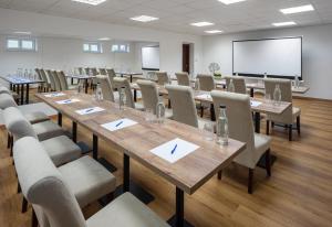 a conference room with tables and chairs and a screen at Wellness Pension AniLife in Číměř +51 photos