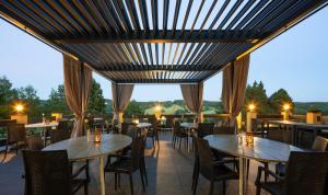 a restaurant with tables and chairs on a patio at Wellness Pension AniLife in Číměř
