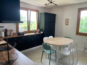 a kitchen with a table and chairs in a room at Casa Tía Maruja in Rianjo