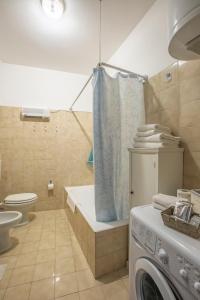 a bathroom with a washing machine and a washer at Da Mara Lago Di Como in Sormano +45 photos