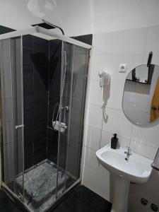 a bathroom with a shower and a sink at My Flat 2 in Praia +32 photos