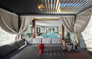 a living room with a couch and a swimming pool at Wellness Pension AniLife in Číměř