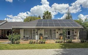 a house with solar panels on the roof at Nestled Peace in Klerksdorp
