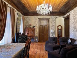 a living room with a chandelier and a couch at Gyumri Heritage House in Gyumri