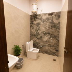 a bathroom with a toilet and a sink at Amrit Farm in Rāi +16 photos
