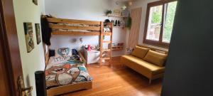 a small room with a bunk bed and a couch at Casa Tía Maruja in Rianjo