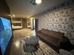 a living room with a couch and a tv at A12 Gallant Fox B02 Suite in Louisville