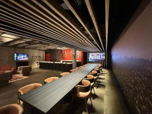 a long long table in a room with chairs at A12 Gallant Fox B02 Suite in Louisville