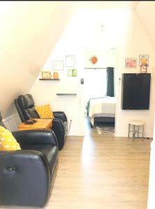a living room with a couch and a flat screen tv at Sunset n Chill in Sunset Beach
