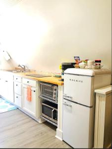 a kitchen with white cabinets and a counter top at Sunset n Chill in Sunset Beach +9 photos