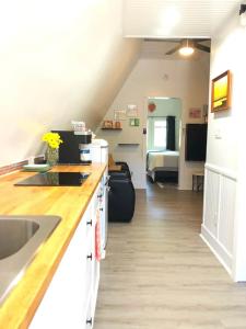 a kitchen with a sink and a living room at Sunset n Chill in Sunset Beach