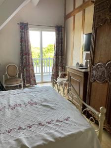 a bedroom with a large bed and a window at Le balcon in Beaumont-le-Hareng