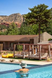 a man swimming in a swimming pool next to a resort at Outbound Sedona in Sedona