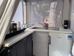 an rv kitchen with a sink and a window at SeaHouse Pakoštane - Hobby in Pakoštane