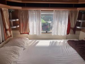 a bed in a room with a window and a bed sidx sidx sidx at SeaHouse Pakoštane - Hobby in Pakoštane