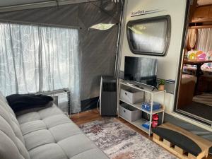 a living room with a couch and a tv in a rv at SeaHouse Pakoštane - Hobby in Pakoštane