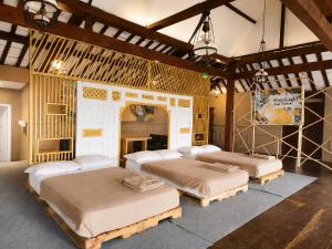 a bedroom with four beds in a room at Dulang Resort & Resto in Bongkar 2 +55 photos