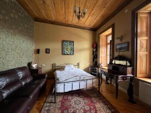 a living room with a bed and a couch at Gyumri Heritage House in Gyumri