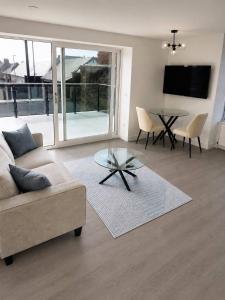 a living room with a couch and a glass table at Dalhousie Residences in Carnoustie