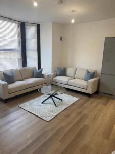 a living room with two couches and a coffee table at Dalhousie Residences in Carnoustie
