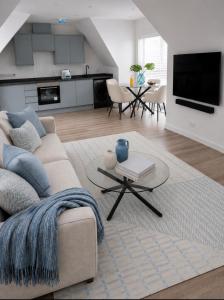 a living room with a couch and a table at Dalhousie Residences in Carnoustie
