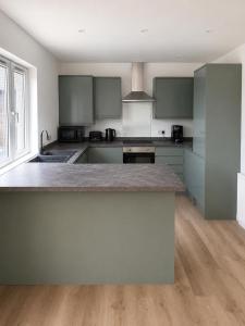 a kitchen with a large counter top in a room at Dalhousie Residences in Carnoustie