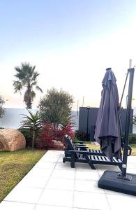 a playground with an umbrella and a swing at The cozy garden suites in Sandton