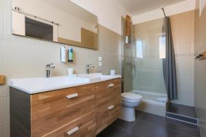 a bathroom with a sink and a toilet and a shower at Hôtel La Baïne in Capbreton