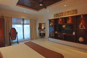 a large living room with a television and a large window at Casa Barco Hotel Boutique in Isla Mujeres +72 photos