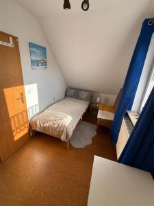 a small room with a bed in a attic at Ruhiges Elbhäuschen nahe Hamburg in Hollern-Twielenfleth +20 photos
