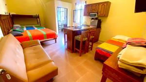 a room with a bedroom with a bed and a desk at Hotel Departamentos Suites in Guanajuato