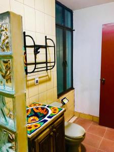 a bathroom with a toilet and a sink at Hotel Departamentos Suites in Guanajuato +20 photos