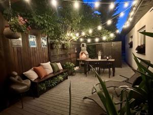 a patio with a table and a bench and lights at Apartamenty Jagodzianka - Jacuzzi, Sauna, Hot-bania, Tężnia in Ustrzyki Dolne